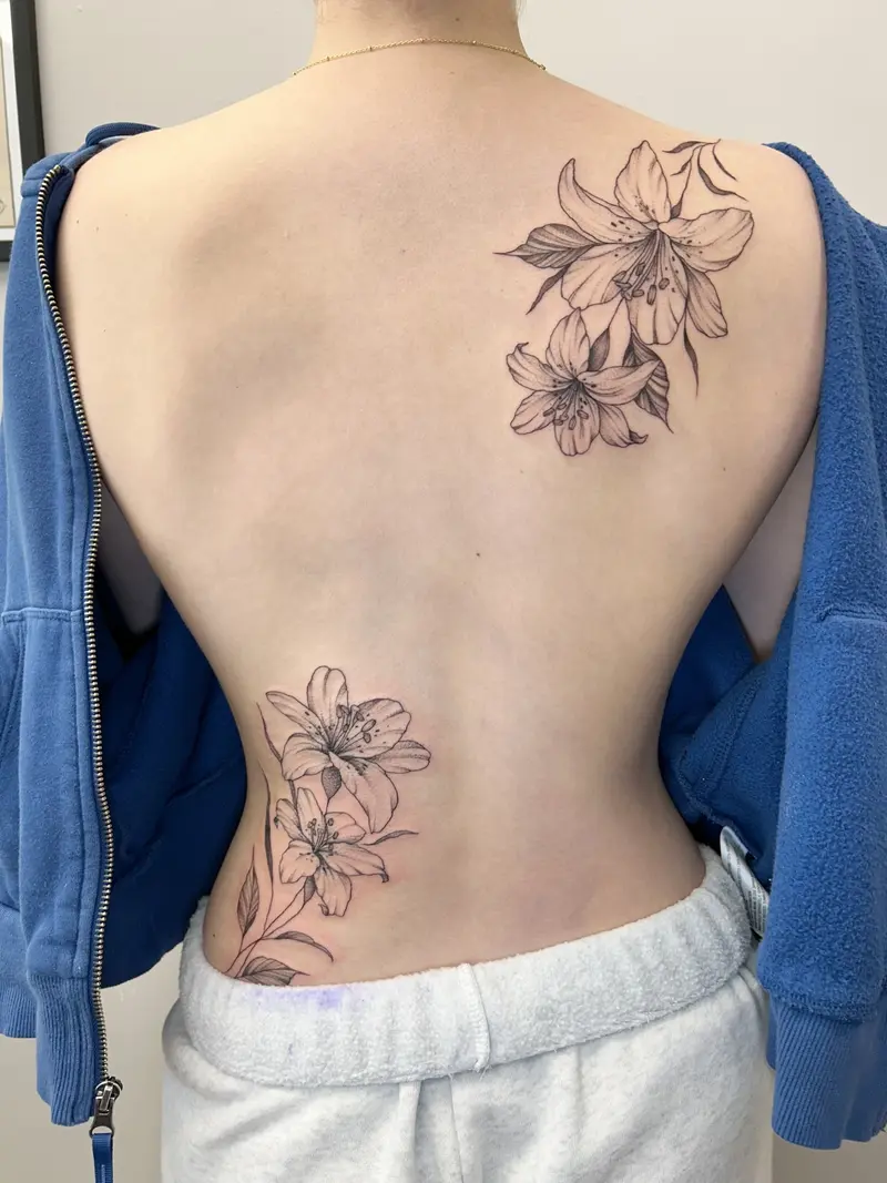 Fun back piece from the other day 🌿#backtattoo #lilies #floraltattoo #finelinetattoo #massachusetts