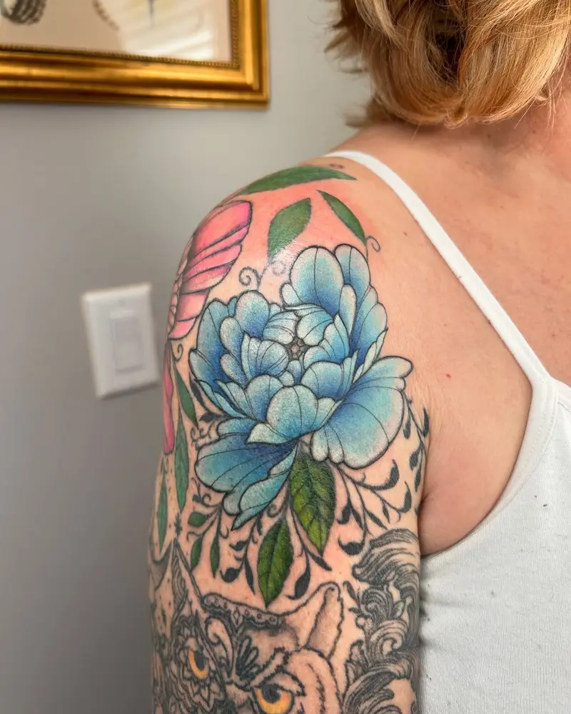 Reworked the line work and color on this piece I originally tattooed in 2020 * * * #peony #bluetattoo #flowertattoo…