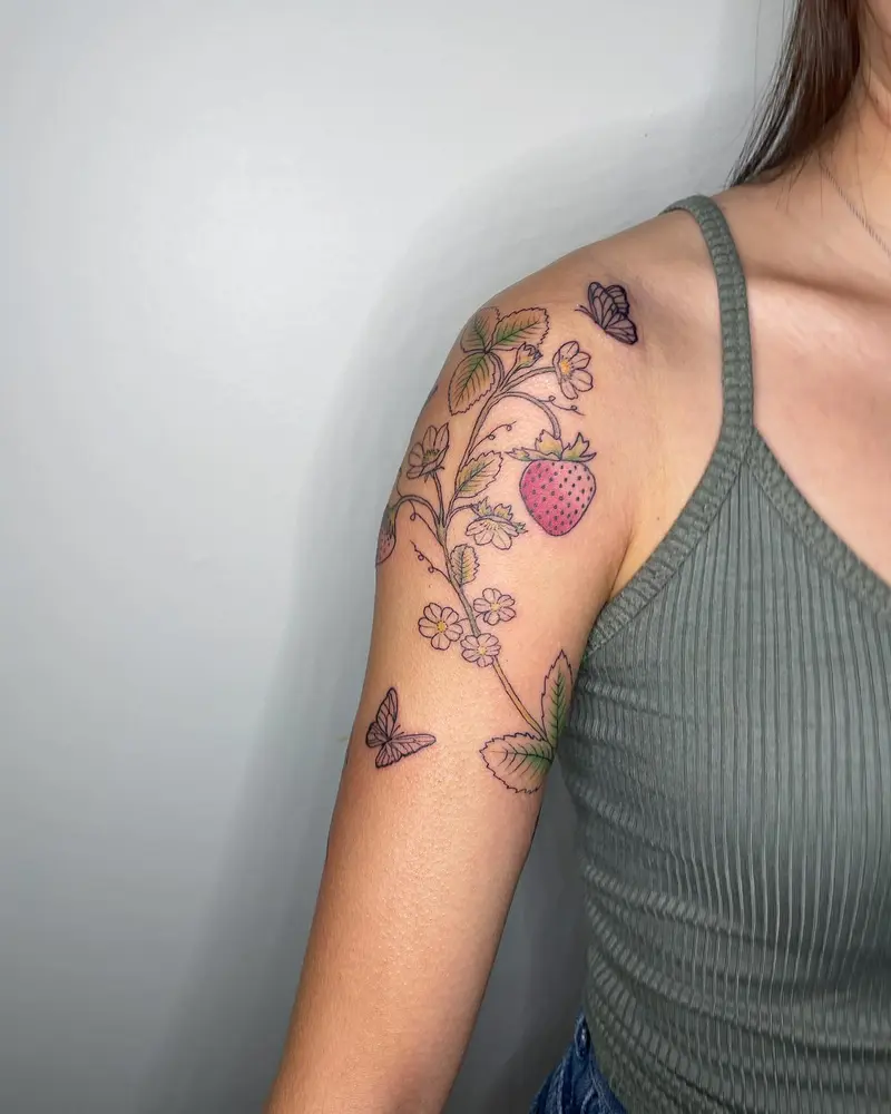 Little strawberry wrap around. Half stenciled half free hand * * * #strawberrytattoo #upperarmtattoo #wraparound…