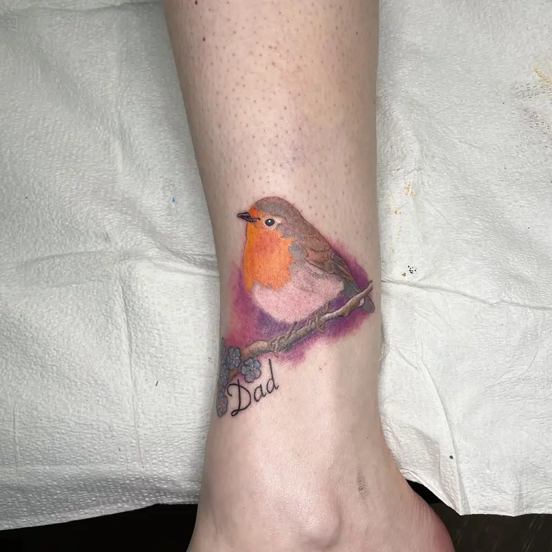 Red breasted robin with some forget me nots as a little memorial piece. * * * #memorialtattoo #robintattoo…