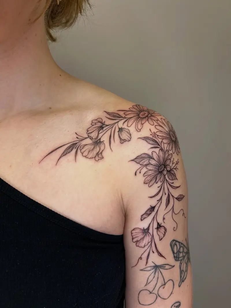 Daisy and sweet pea shoulder piece done earlier this week 🥰 * * * #shouldertattoo #birthflowers #daisies #sweetpea…