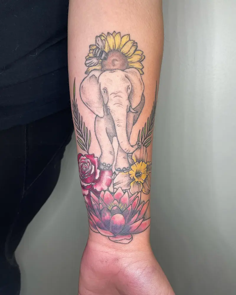 Added on to the elephant and water lily I did a couple years ago. Swipe to see more angles * * * #elephanttattoo #rose…
