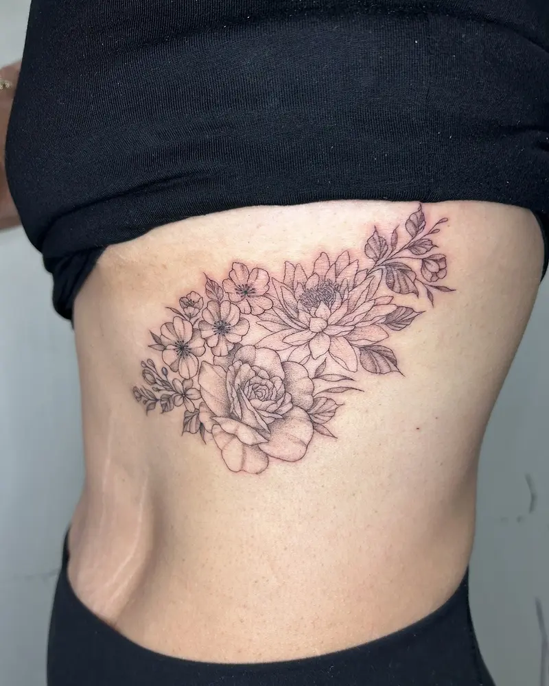 Fine line rib tattoo. Kristen sat like a champ for this one! * * * #ribtattoo #birthflowers #birthmonthflowers…