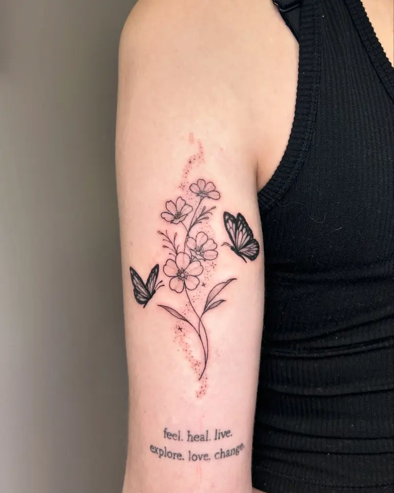 A cute floral design above healed writing from a while back. * * * #butterflytattoo #floraltattoo #flowers #sparkles…